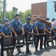 A resident of Ferguson, Mo., speaks to Missouri Highway Patrol officers in riot gear outside Ferguson Police Department Headquarters during a protest of the shooting death of 18-year-old Michael Brown by a Ferguson police officer Aug. 11, 2014.
Michael B. Thomas/Getty Images